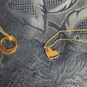 Silver tone mother and daughter necklaces.